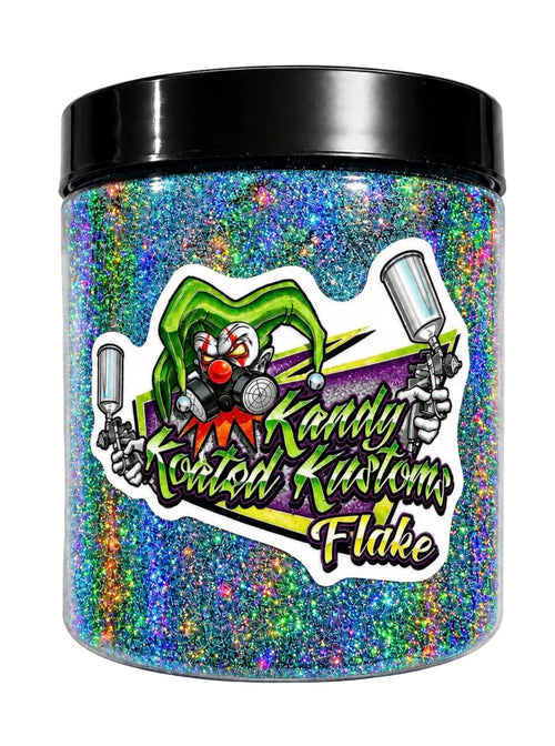 A clear plastic jar filled with holographic glitter in blue, green, purple, and orange tones, with a black lid. A large sticker on the front shows a clown and the text 'Kandy Coated Kustoms Flake'.